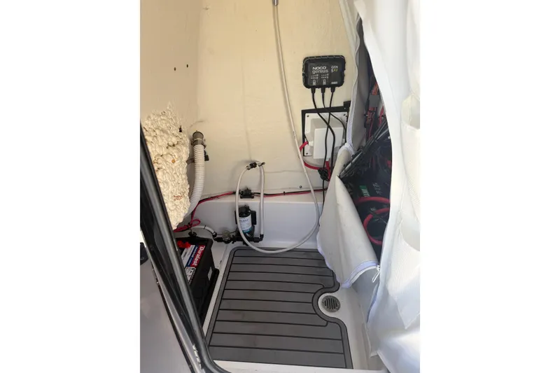 Slide: The Image of Interior view of 2022 Tidewater 2410 Bay Max boat's utility compartment with equipment and wiring. - 34