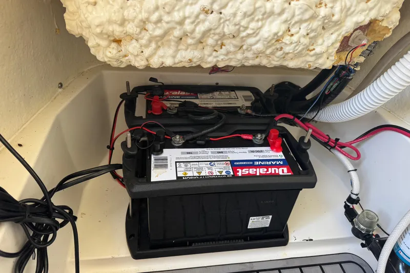 Slide: The Image of Marine batteries in a 2022 Tidewater 2410 Bay Max boat compartment. - 38