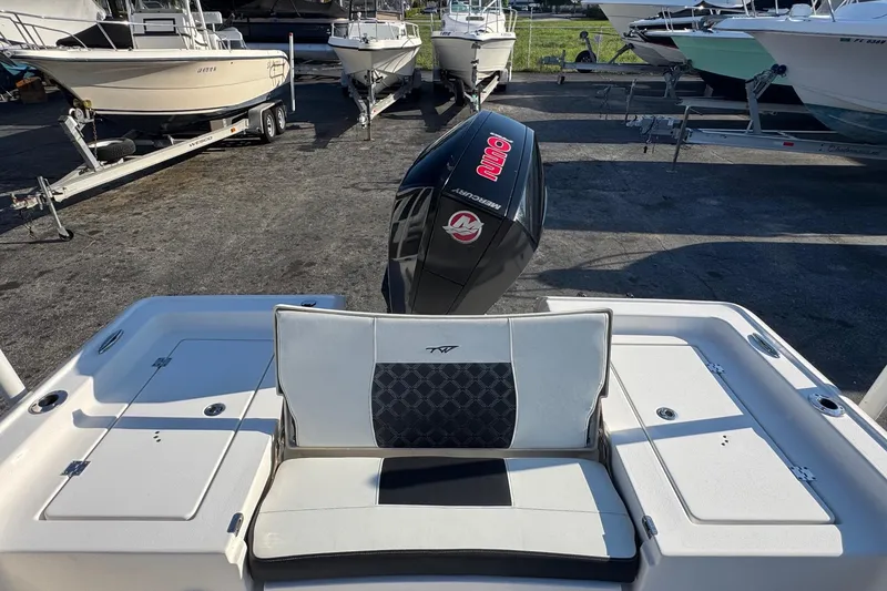 Slide: The Image of 2022 Tidewater 2410 Bay Max boat with Mercury engine, parked among other boats. - 40