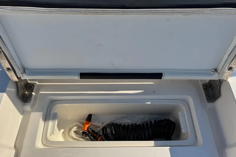 Slide: The Image of Open storage compartment on 2022 Tidewater 2410 Bay Max boat with coiled rope inside. - 42