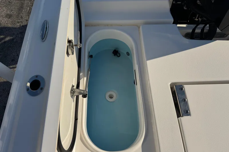 Slide: The Image of Livewell compartment on a 2022 Tidewater 2410 Bay Max boat, open and filled with water. - 44
