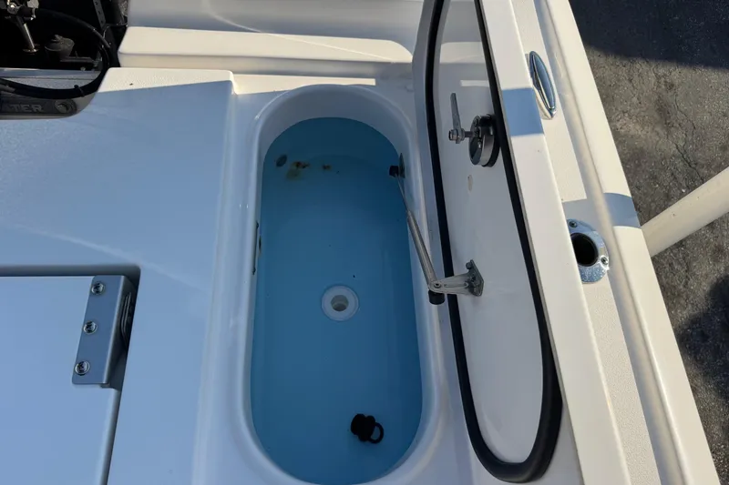 Slide: The Image of Livewell compartment on a 2022 Tidewater 2410 Bay Max boat, open lid view. - 45
