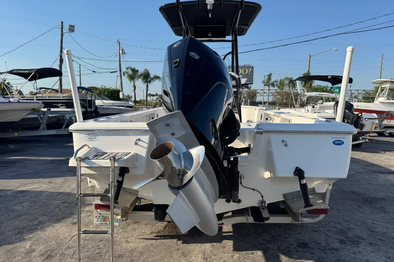 Slide: The Image of 2022 Tidewater 2410 Bay Max boat with powerful outboard motor in a marina setting. - 54
