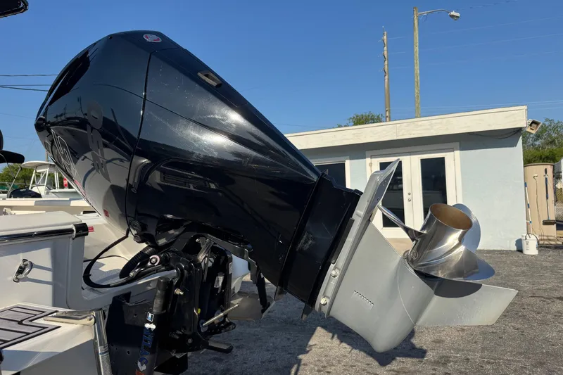 Slide: The Image of 2022 Tidewater 2410 Bay Max boat with powerful outboard motor in a sunny setting. - 55