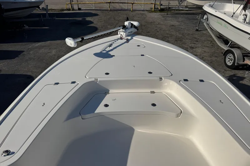 Slide: The Image of 2022 Tidewater 2410 Bay Max boat deck with storage compartments and trolling motor. - 6