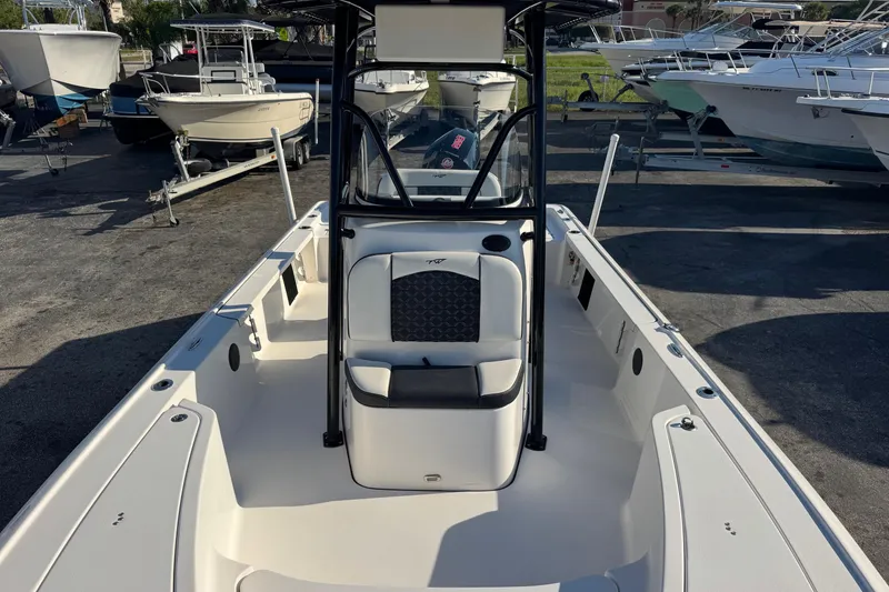 Slide: The Image of 2022 Tidewater 2410 Bay Max boat, interior view, parked among other boats. - 7
