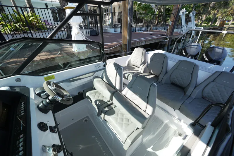 Slide: The Image of 2021 Axopar 28 T-Top boat interior with modern seating and steering wheel. - 21