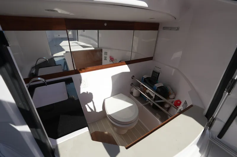 Slide: The Image of 2021 Axopar 28 T-Top boat interior with toilet and sink. - 25