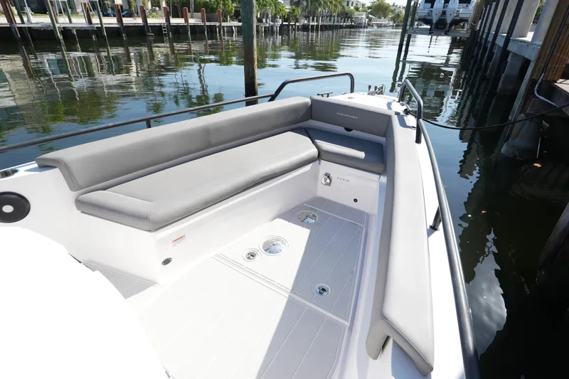 Slide: The Image of 2021 Axopar 28 T-Top boat with sleek seating, docked by calm waters. - 27
