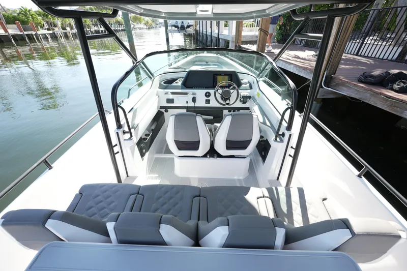 Slide: The Image of 2021 Axopar 28 T-Top boat interior with modern seating and steering console. - 31