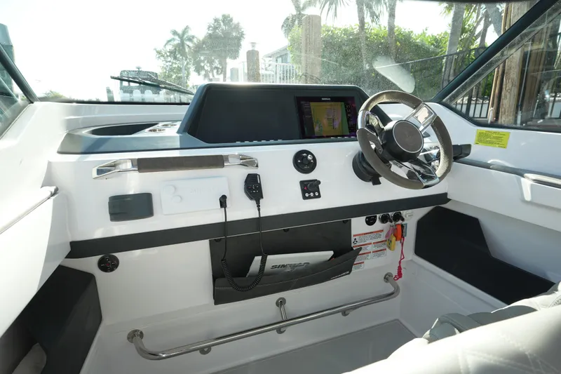 Slide: The Image of Interior view of 2021 Axopar 28 T-Top boat cockpit with steering wheel and controls. - 33