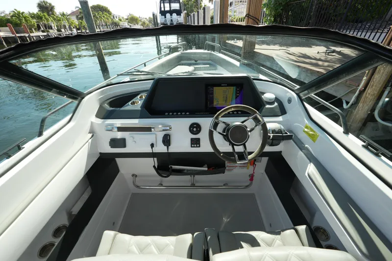 Slide: The Image of 2021 Axopar 28 T-Top boat cockpit with modern steering and navigation system. - 34