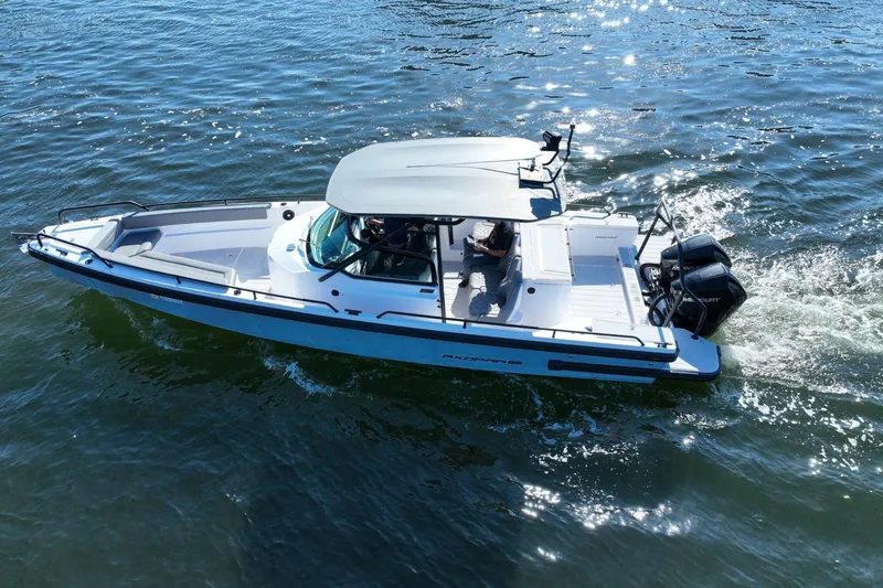 Slide: The Image of 2021 Axopar 28 T-Top boat cruising on water under sunny skies. - 6