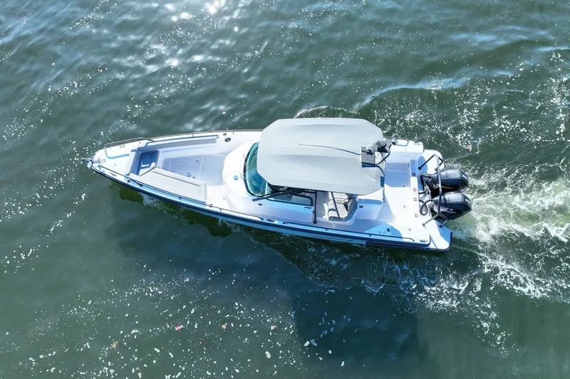 Slide: The Image of 2021 Axopar 28 T-Top boat cruising on water, aerial view. - 7