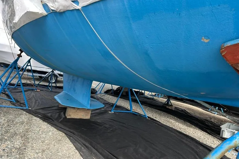 Slide: The Image of Blue hull of a 1998 Catalina 36 MkII sailboat on stands, under maintenance. - 15