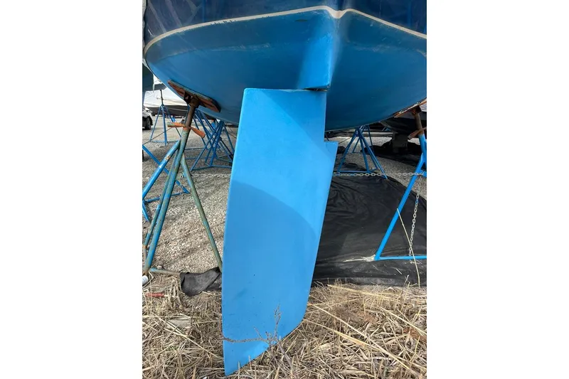 Slide: The Image of 1998 Catalina 36 MkII sailboat keel on stands, blue hull, outdoor storage. - 18