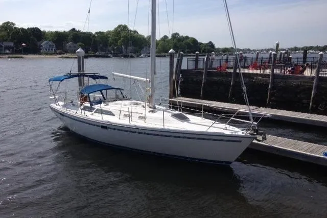 Slide: The Image of 1998 Catalina 36 MkII sailboat docked by a marina on a sunny day. - 2