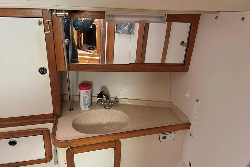 Slide: The Image of Interior of a 1998 Catalina 36 MkII sailboat bathroom with sink and mirror. - 30