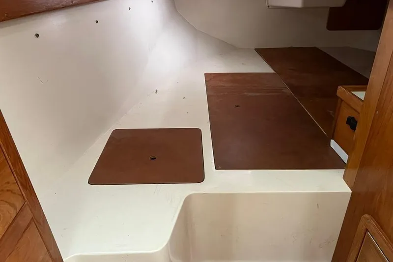 Slide: The Image of Interior view of a 1998 Catalina 36 MkII sailboat cabin with wooden flooring. - 33