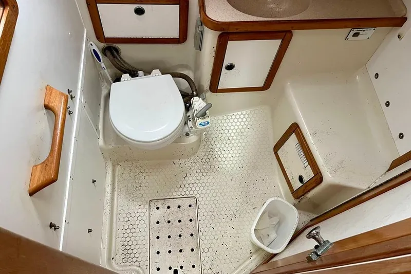 Slide: The Image of Bathroom interior of a 1998 Catalina 36 MkII sailboat, featuring a compact toilet and sink. - 38