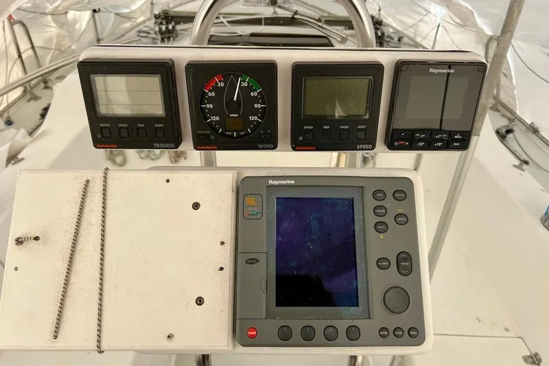 Slide: The Image of Cockpit instruments of a 1998 Catalina 36 MkII sailboat, featuring Raymarine displays. - 4