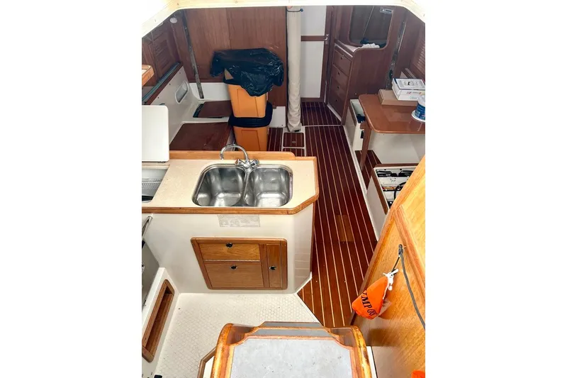 Slide: The Image of Interior of 1998 Catalina 36 MkII sailboat with wood finishes and compact kitchen area. - 44