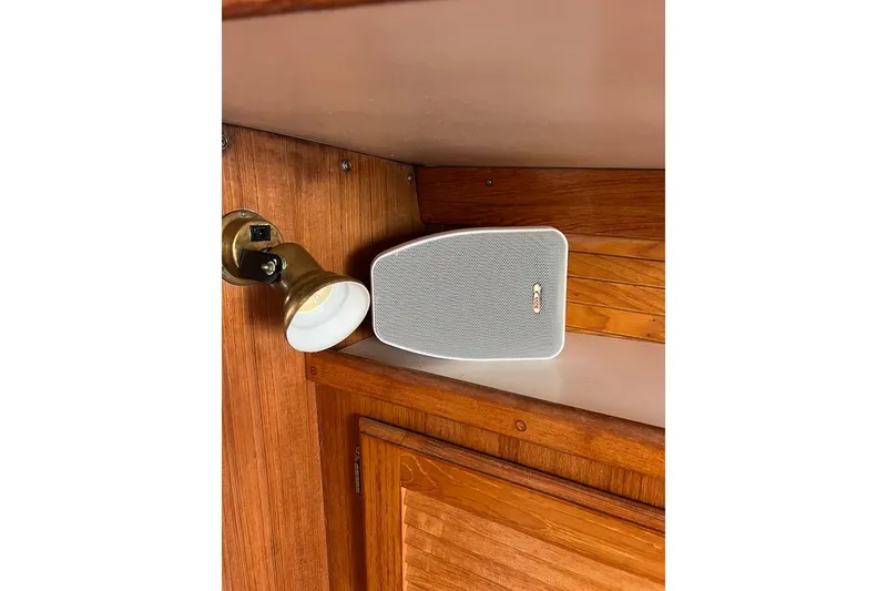 Slide: The Image of Speaker and brass light fixture inside 1998 Catalina 36 MkII sailboat cabin. - 45