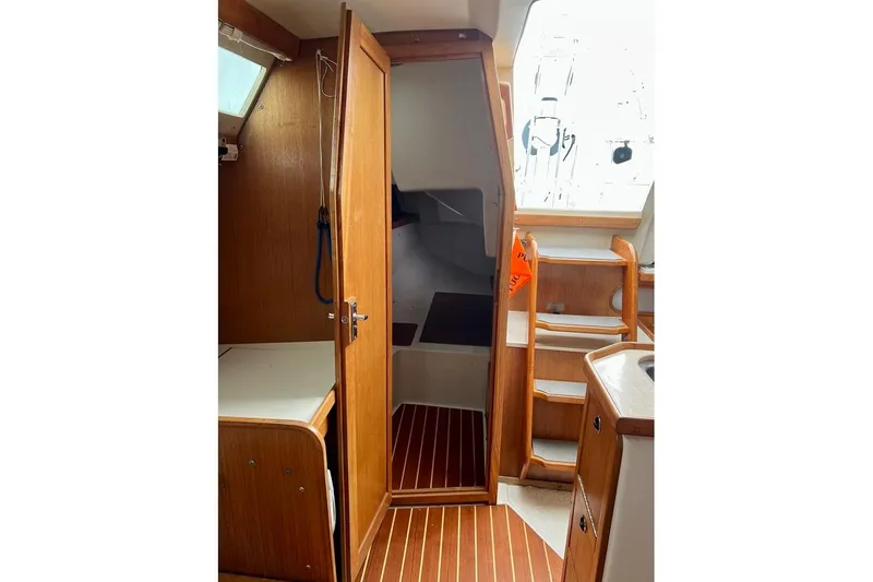 Slide: The Image of Interior of 1998 Catalina 36 MkII sailboat with wooden cabinetry and steps. - 49