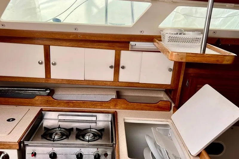 Slide: The Image of Interior of a 1998 Catalina 36 MkII sailboat kitchen with stove and storage cabinets. - 50