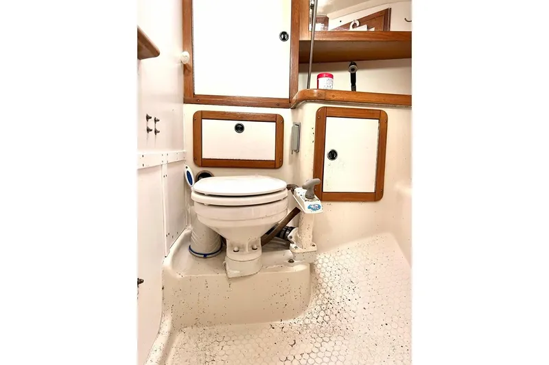Slide: The Image of 1998 Catalina 36 MkII yacht bathroom with toilet and wooden cabinets. - 52