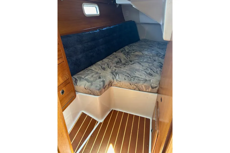 Slide: The Image of Cozy cabin interior of 1998 Catalina 36 MkII sailboat with wooden flooring and cushioned bed. - 62