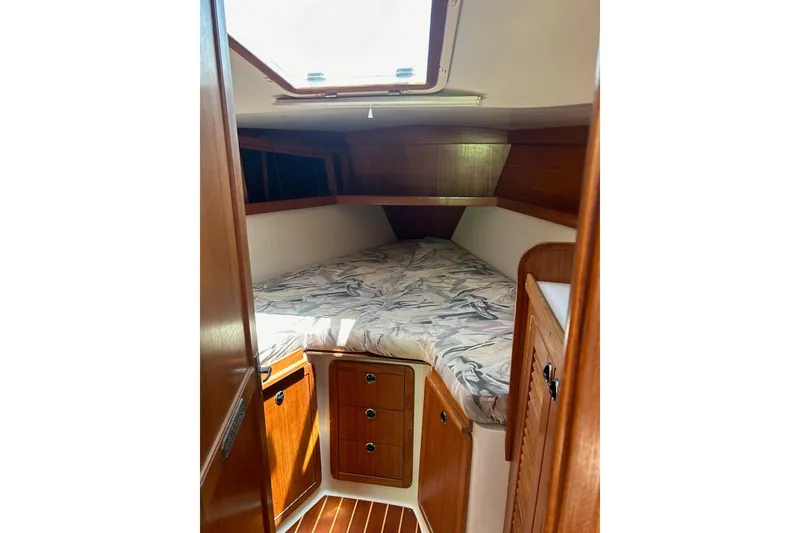Slide: The Image of Cozy cabin interior of 1998 Catalina 36 MkII sailboat with wooden cabinetry and patterned bedding. - 63