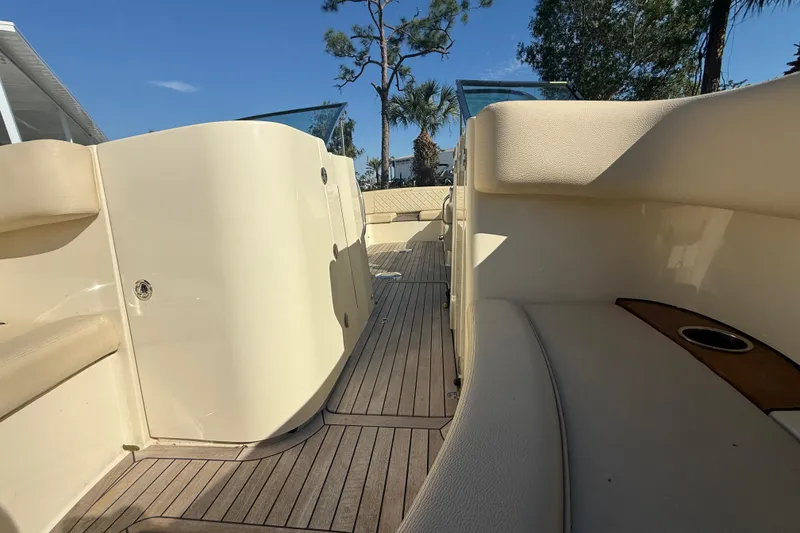Slide: The Image of 2018 Chris-Craft Launch 30 interior with beige seating and wooden deck. - 12