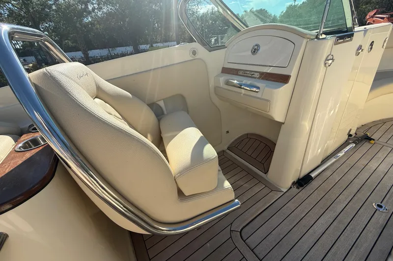 Slide: The Image of 2018 Chris-Craft Launch 30 interior with beige seating and wooden accents. - 13