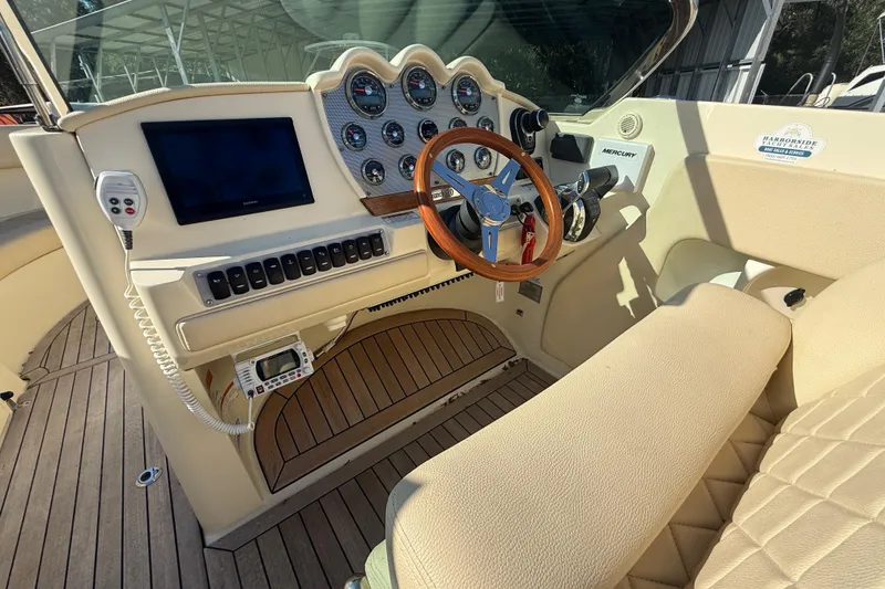 Slide: The Image of 2018 Chris-Craft Launch 30 dashboard with wooden steering wheel and modern controls. - 14