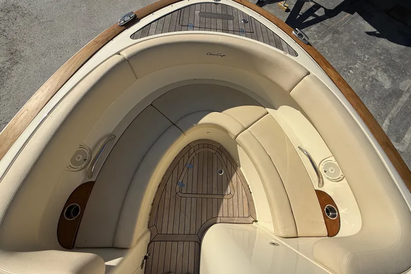 Slide: The Image of 2018 Chris-Craft Launch 30 boat interior with beige seating and wooden deck. - 15