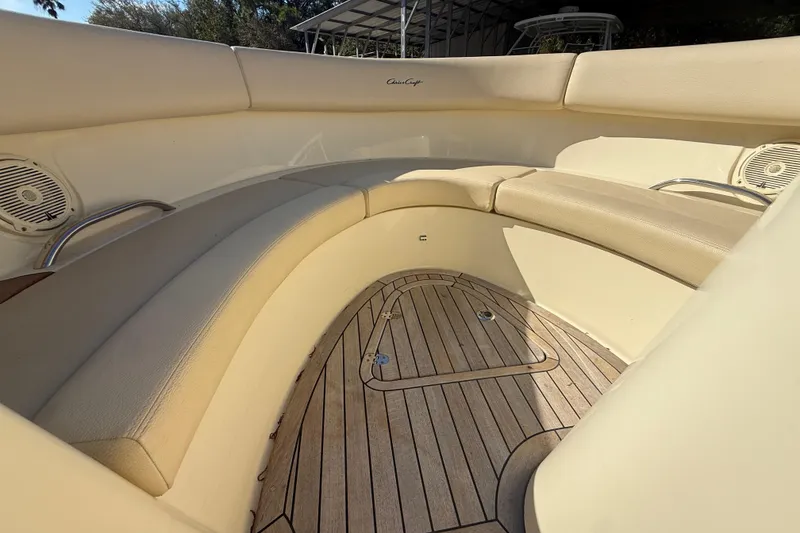 Slide: The Image of 2018 Chris-Craft Launch 30 boat interior with beige seating and wooden flooring. - 16