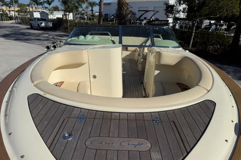 Slide: The Image of 2018 Chris-Craft Launch 30 boat with elegant seating and teak deck in a sunny marina. - 21