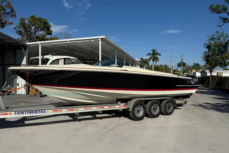 Slide: The Image of 2018 Chris-Craft Launch 30 boat on trailer, parked outdoors under clear blue sky. - 3