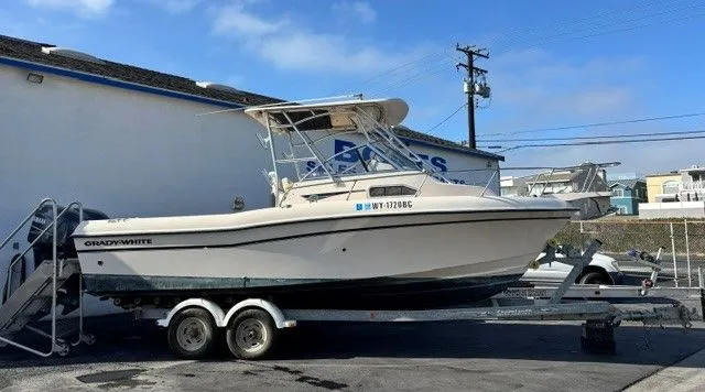 Slide: The Image of A 2007 Grady-White Gulfstream 232 boat on a trailer in front of a building. - 1