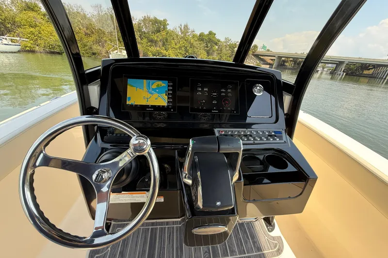 Slide: The Image of 2025 Scout 277 LXF boat helm with navigation display and steering wheel. - 13
