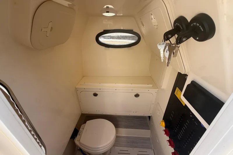 Slide: The Image of Interior of 2025 Scout 277 LXF boat cabin with toilet and control panel. - 18