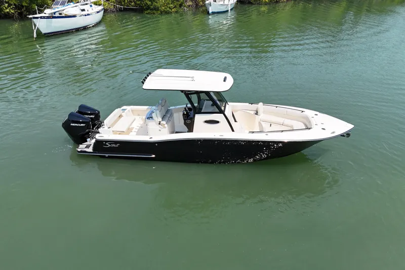 Slide: The Image of 2025 Scout 277 LXF boat on calm water, featuring sleek design and dual Mercury engines. - 3