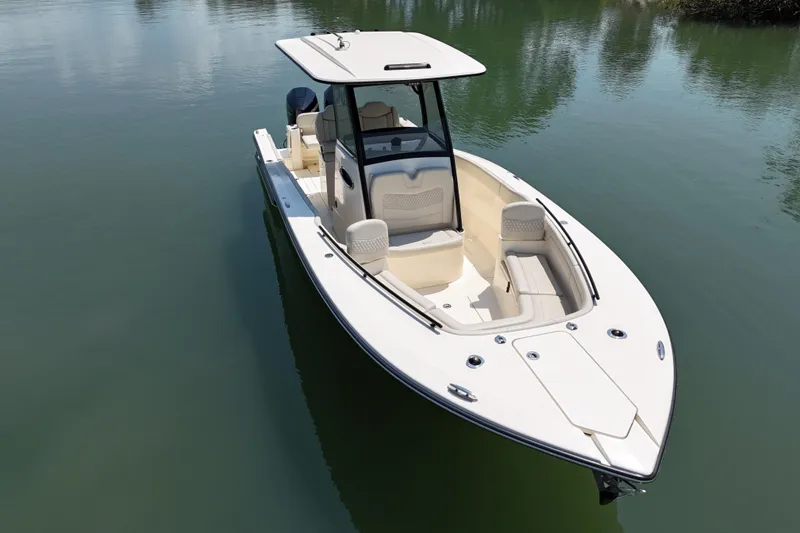 Slide: The Image of 2025 Scout 277 LXF boat on calm water, showcasing sleek design and spacious seating. - 5