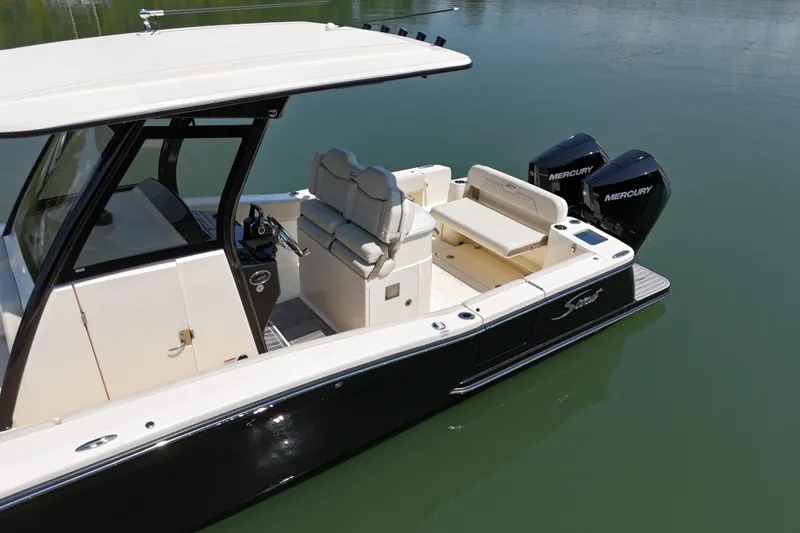 Slide: The Image of 2025 Scout 277 LXF boat with dual Mercury engines on calm water. - 6