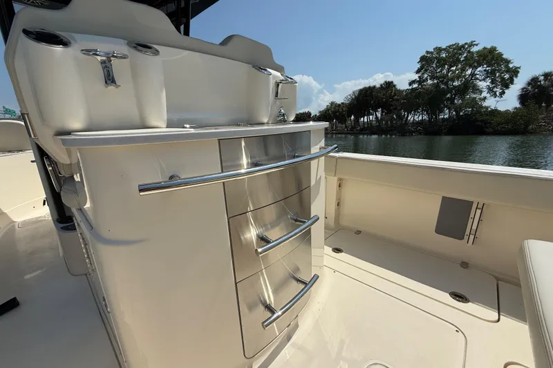 Slide: The Image of 2025 Scout 277 LXF boat interior with sleek storage drawers and scenic water view. - 9