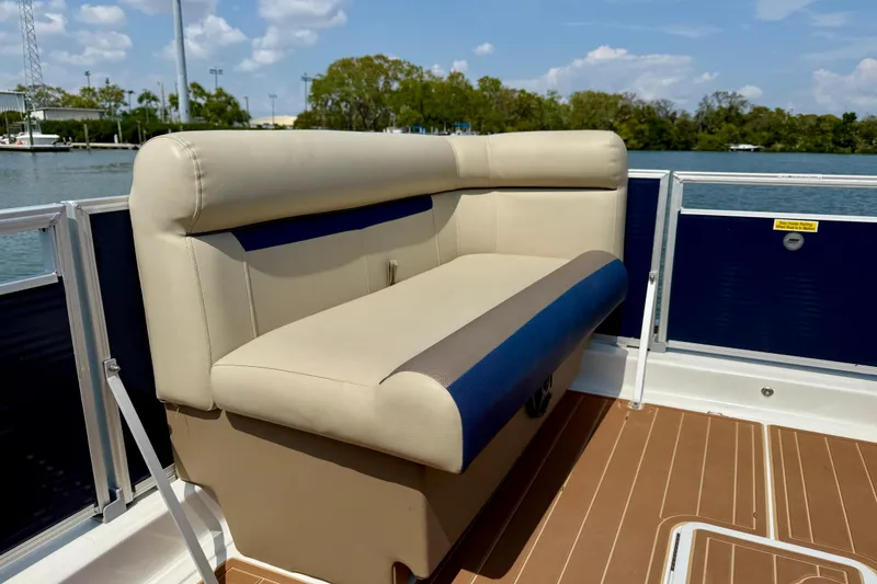 Slide: The Image of 2022 Hurricane FunDeck 2260 REF boat interior with beige seating and wooden deck. - 11