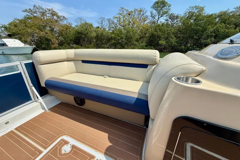 Slide: The Image of 2022 Hurricane FunDeck 2260 REF boat interior with cushioned seating and cup holder. - 12