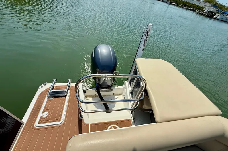 Slide: The Image of 2022 Hurricane FunDeck 2260 REF boat with outboard motor on calm water. - 21