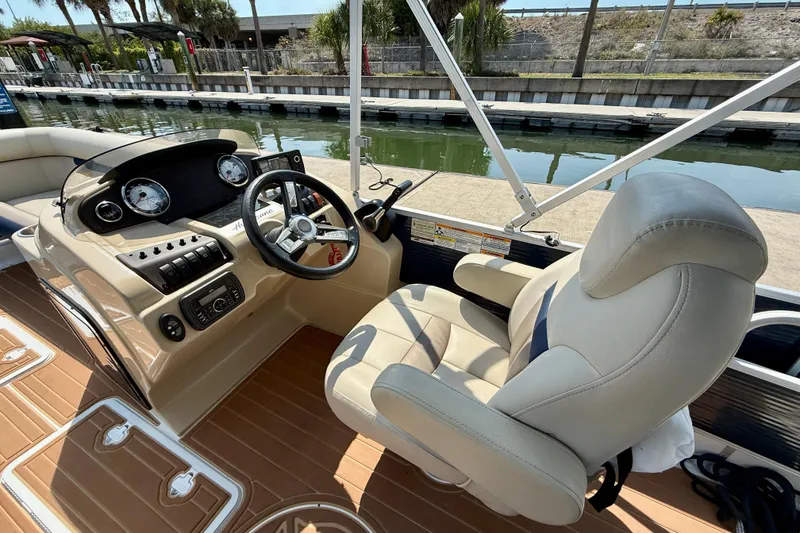 Slide: The Image of 2022 Hurricane FunDeck 2260 REF boat cockpit with steering wheel and controls. - 25